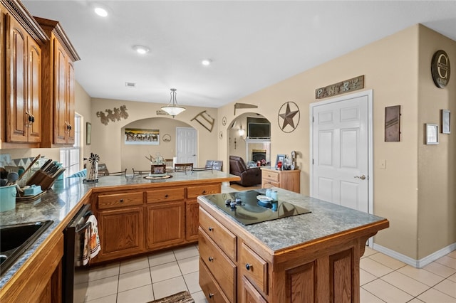 kitchen with dishwasher, a kitchen island, hanging light fixtures, and light tile patterned floors