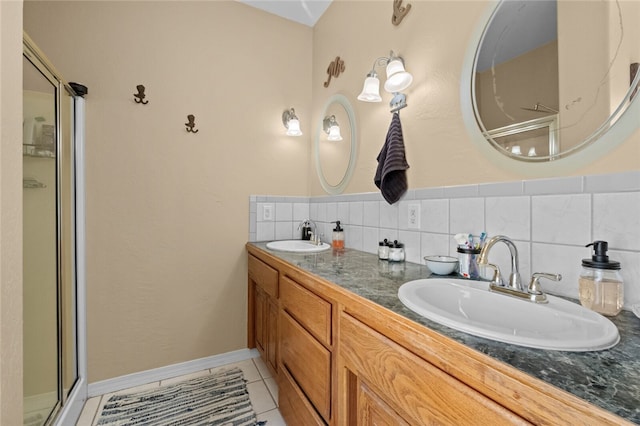 bathroom with decorative backsplash, tile patterned flooring, an enclosed shower, and vanity