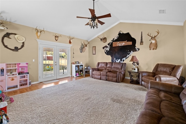 living room featuring wood-type flooring, vaulted ceiling, crown molding, ceiling fan, and french doors