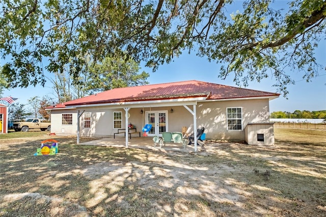 rear view of house featuring french doors and a patio