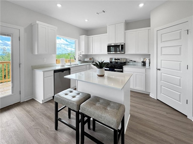 5395 Selah St, Springdale, AR 72764 - kitchen with stainless steel appliances, white cabinets, light countertops, a center island, and recessed lighting