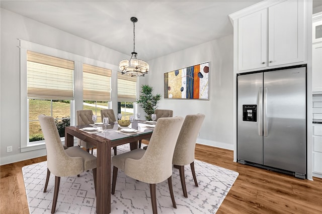 dining area with a chandelier and hardwood / wood-style floors