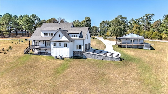 back of house featuring a lawn and a deck