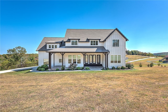 view of front of house with a front yard and a porch