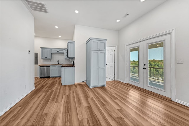 kitchen with appliances with stainless steel finishes, light hardwood / wood-style floors, gray cabinets, and french doors