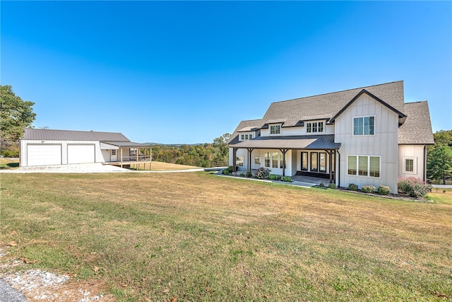 view of front of property featuring a front yard, a porch, and a garage