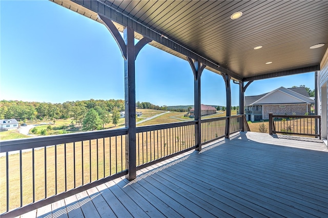 wooden terrace with a lawn