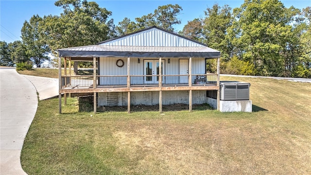 back of property with a yard and french doors