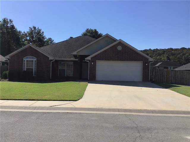 ranch-style home with a garage and a front yard