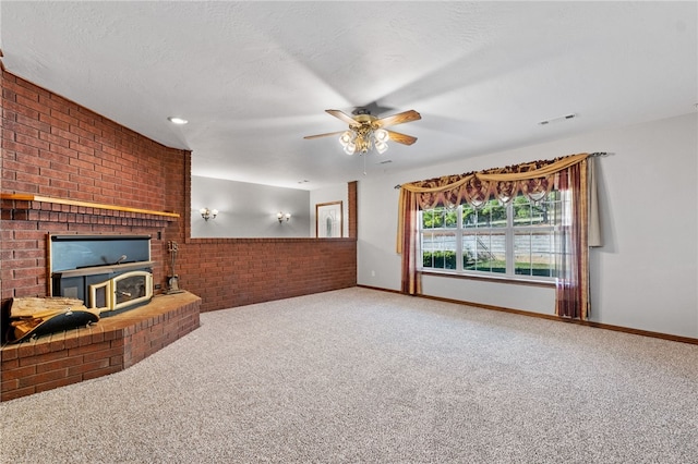 living room with carpet, ceiling fan, a textured ceiling, and brick wall