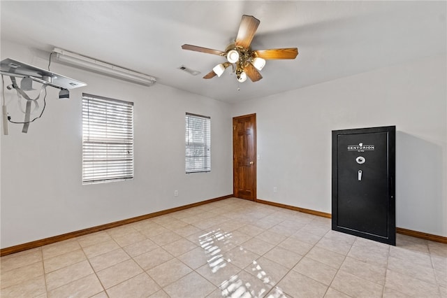 empty room featuring ceiling fan and light tile patterned flooring