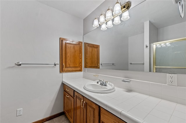 bathroom with tile patterned flooring, vanity, and a shower with door