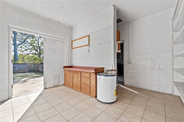 kitchen with light tile patterned floors and water heater