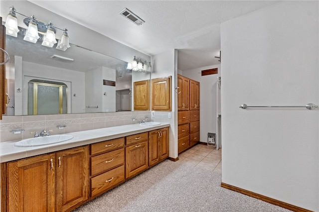 bathroom with walk in shower, tasteful backsplash, tile patterned flooring, a textured ceiling, and vanity