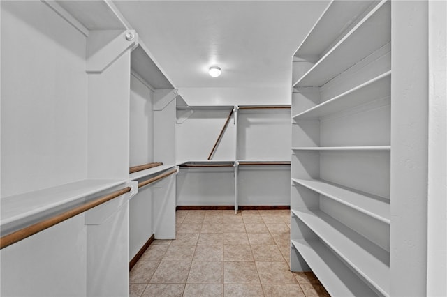 spacious closet featuring light tile patterned floors