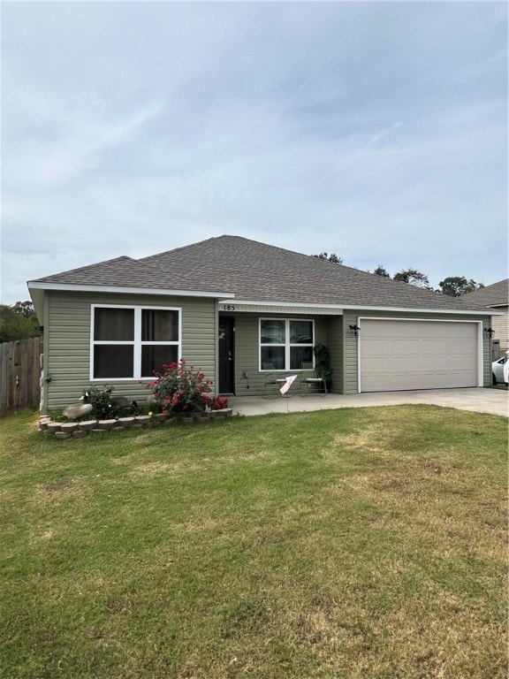 single story home featuring a garage and a front lawn