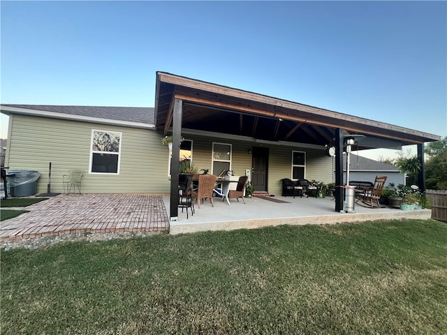 rear view of property with a yard and a patio