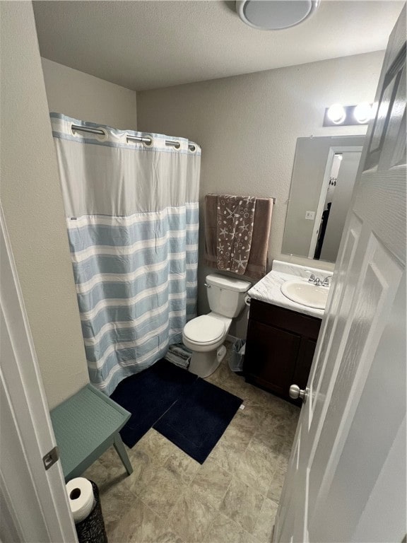 bathroom with vanity, toilet, and a shower with shower curtain