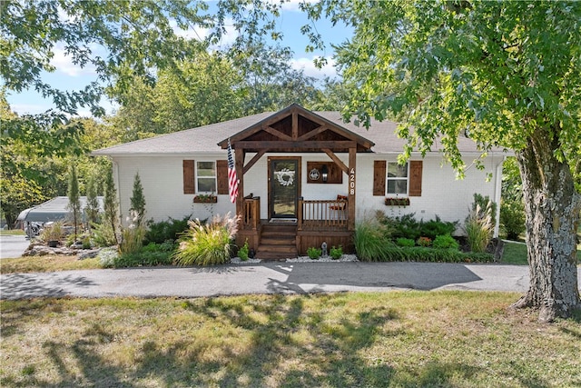 view of front facade with a front yard and a porch