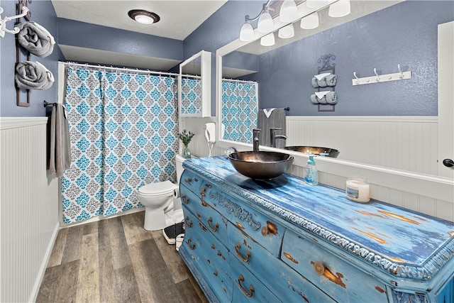 bathroom featuring vanity, hardwood / wood-style floors, and toilet