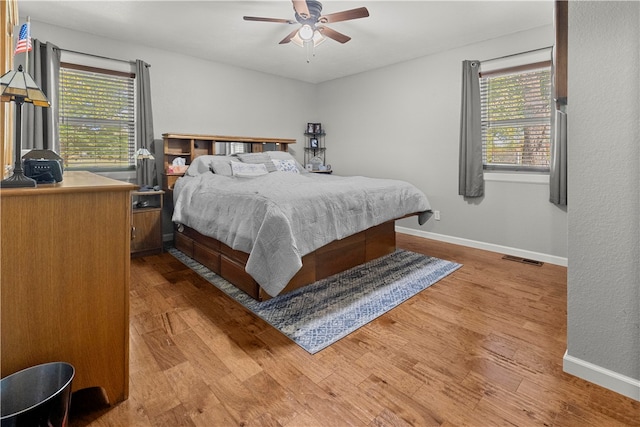 bedroom with ceiling fan and light wood-type flooring