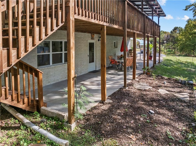 view of property exterior with a patio and a deck