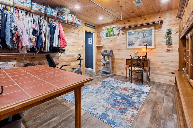 interior space featuring wood walls, hardwood / wood-style floors, and wooden ceiling