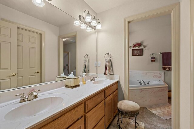 bathroom featuring tile patterned flooring, a relaxing tiled tub, and vanity