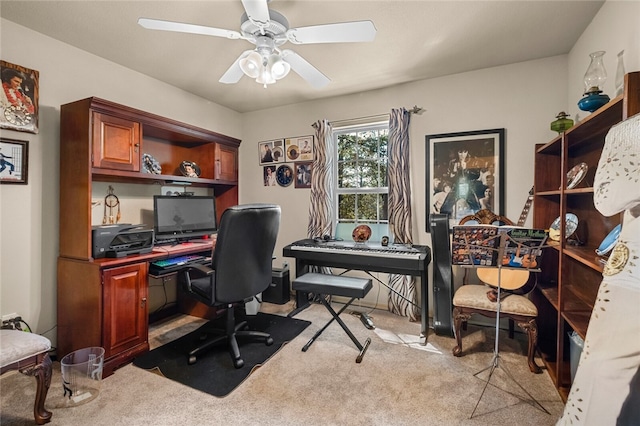 carpeted office space featuring ceiling fan