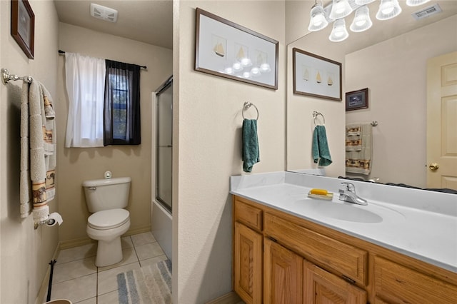 full bathroom featuring tile patterned floors, vanity, toilet, and enclosed tub / shower combo