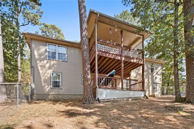 back of house featuring a wooden deck