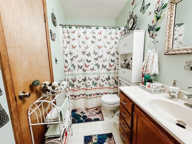 bathroom featuring a textured ceiling, toilet, and vanity