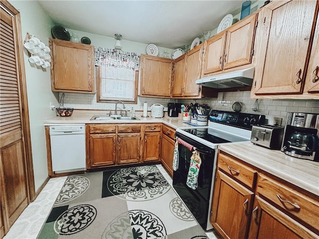 kitchen with white dishwasher, sink, range with electric cooktop, and tasteful backsplash