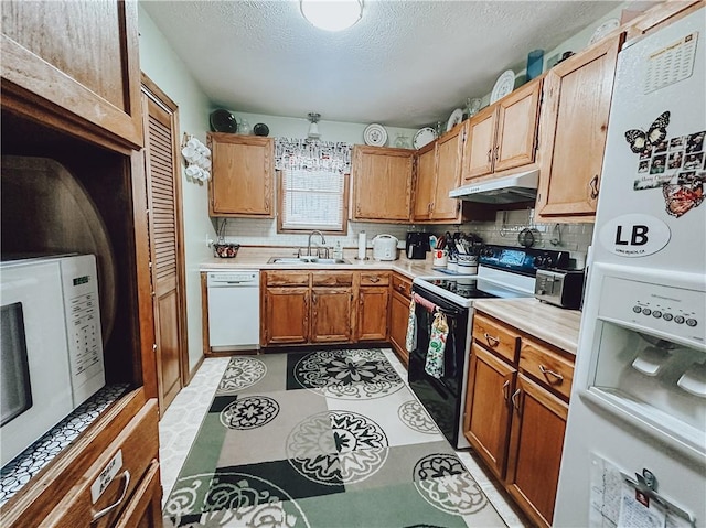 kitchen with light tile patterned floors, decorative backsplash, white appliances, a textured ceiling, and sink