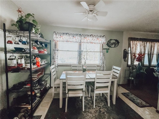 dining area featuring ceiling fan and carpet flooring