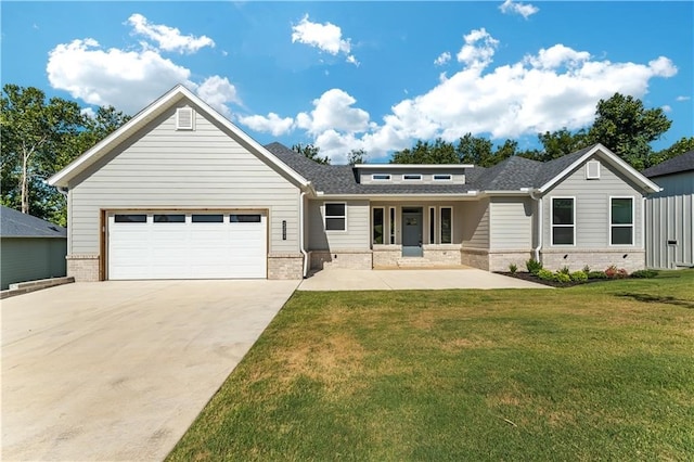 view of front of property with a front yard and a garage