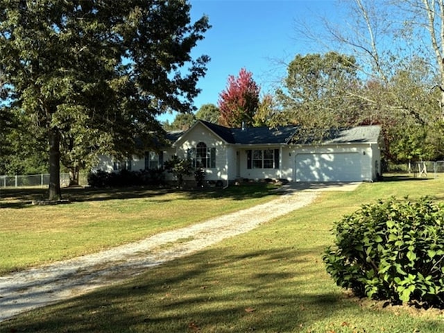 view of front of home with a front lawn and a garage