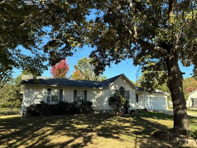 single story home featuring a front lawn and a garage