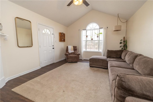 living room featuring ceiling fan, dark hardwood / wood-style flooring, and vaulted ceiling