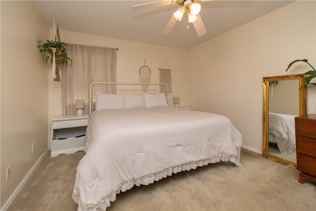 bedroom with ceiling fan and light colored carpet