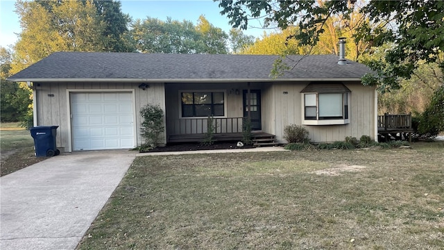 single story home featuring a garage and a front lawn