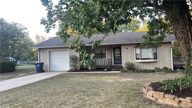 ranch-style home with covered porch, a front yard, and a garage