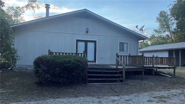 rear view of property featuring a wooden deck