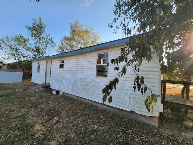 view of property exterior with a deck