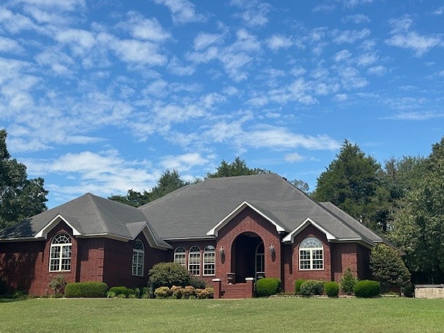 ranch-style home featuring a front lawn