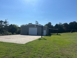 view of yard with a garage and an outdoor structure