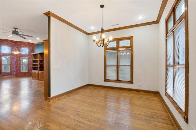 unfurnished room featuring crown molding, ceiling fan with notable chandelier, and light hardwood / wood-style floors