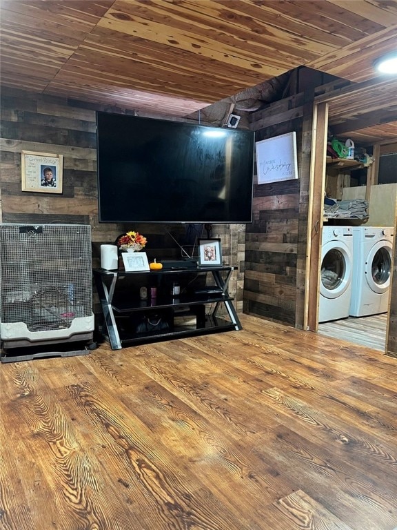 interior space featuring wooden walls, washing machine and clothes dryer, and wood ceiling