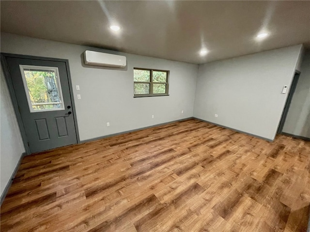 interior space featuring hardwood / wood-style floors and a wall unit AC