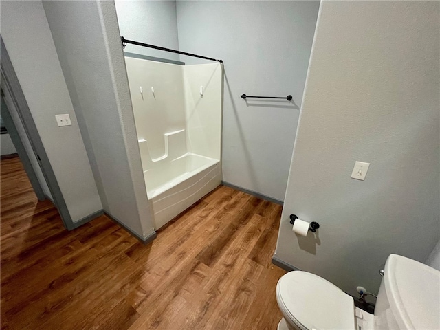 bathroom featuring hardwood / wood-style floors, toilet, and  shower combination